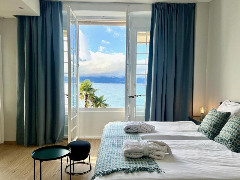 Quarto do Eden Palace au Lac, dica de onde ficar em Montreux, com cama de casal e vista para o lago