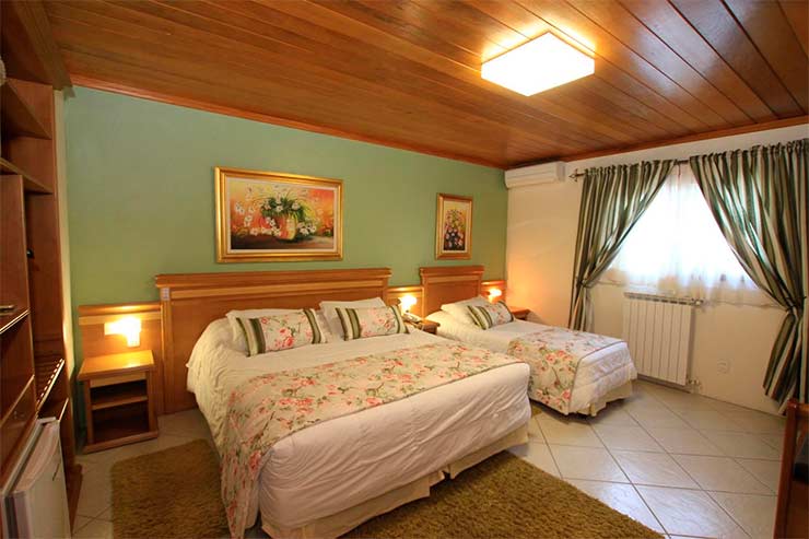 Onde ficar em Gramado: Quarto da Pousada Águia Branca com cama de casal e de solteiro (Foto: Divulgação)