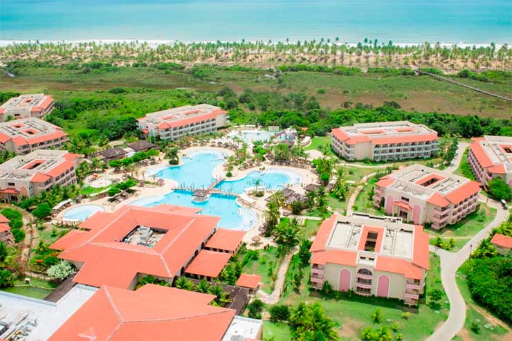 Resorts all inclusive no Nordeste:  Piscinas e acomodações do Grand Palladium Imbassaí em frente à praia