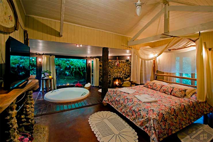 Quarto espaçoso da Fazenda do Mel com cama de casal e banheira