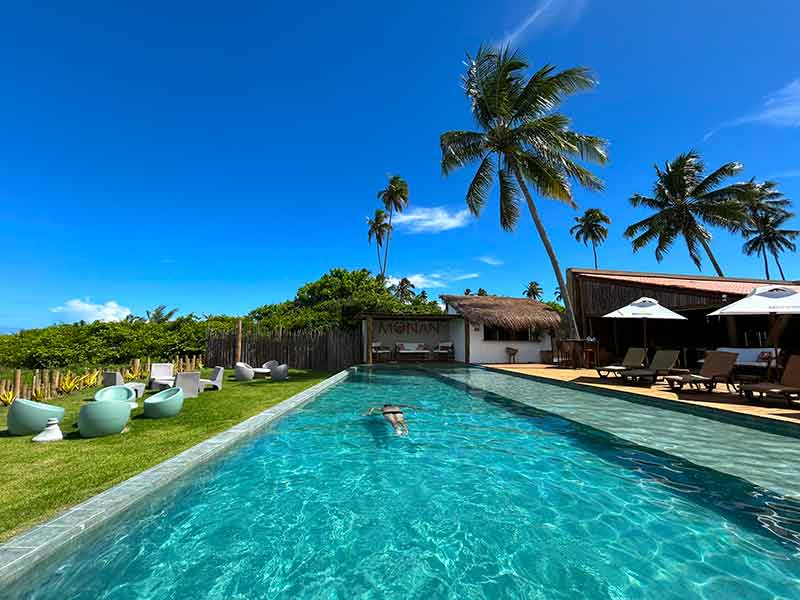 Homem nada na piscina do Monan Boutique Hotel, dica de all inclusive no Nordeste, em Alagoas