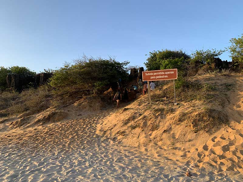 Acesso às dunas petrificadas com placa dizendo que apenas pedestres são aceitos