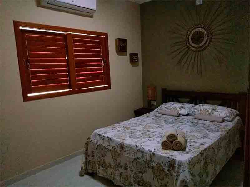 Quarto simples da Maragogi Chalé Antunes com cama de casal e ar-condicionado