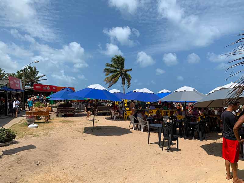 Barracas amontoadas nas areias da praia de Coqueirinho, no Conde