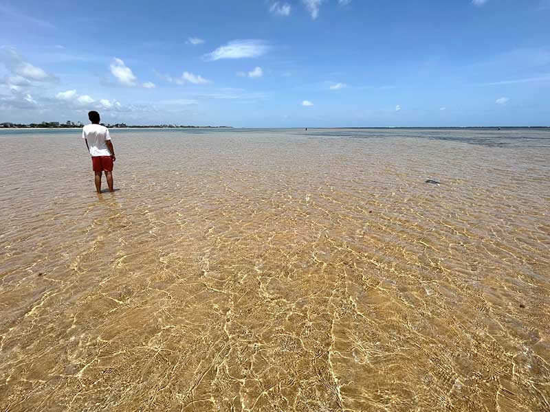 Homem em Areia Vermelha. É importante saber da maré para decidir quando ir pra João Pessoa