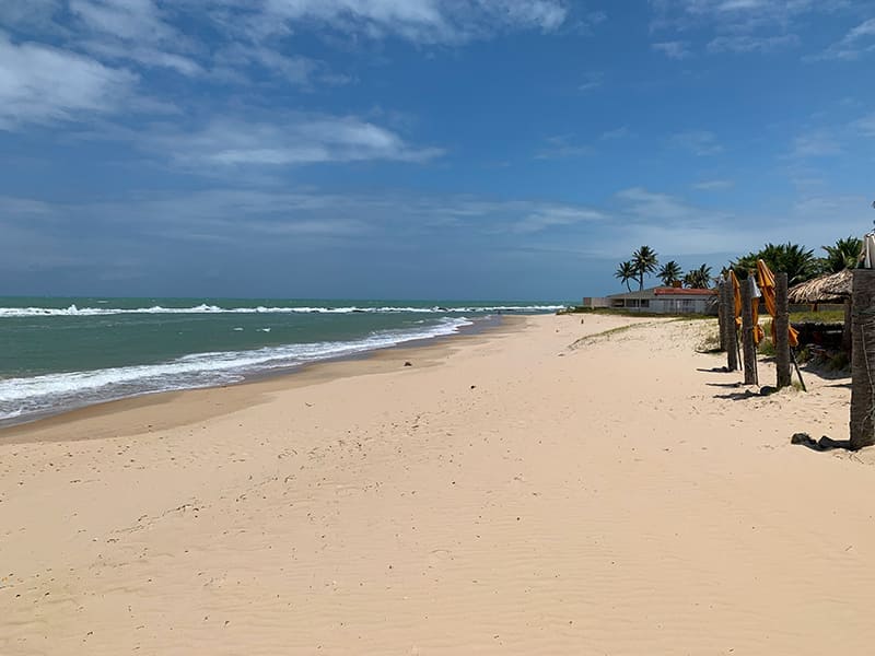 Praia vazia e mar com ondas da Barra de Tabatinga, no Rio Grande do Norte