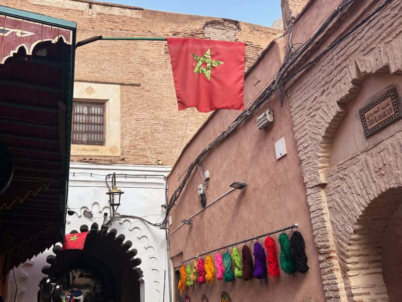 Bandeira do Marrocos entre as construções vermelhas da Medina