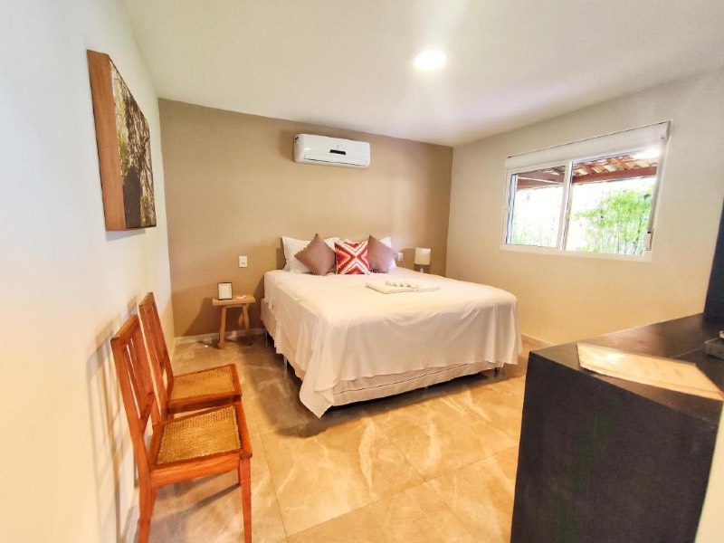 Quarto da Villa Magna com cama de casal e ar-condicionado