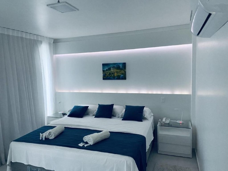 Quarto do Hotel Real com cama de casal e decoração branca e azul