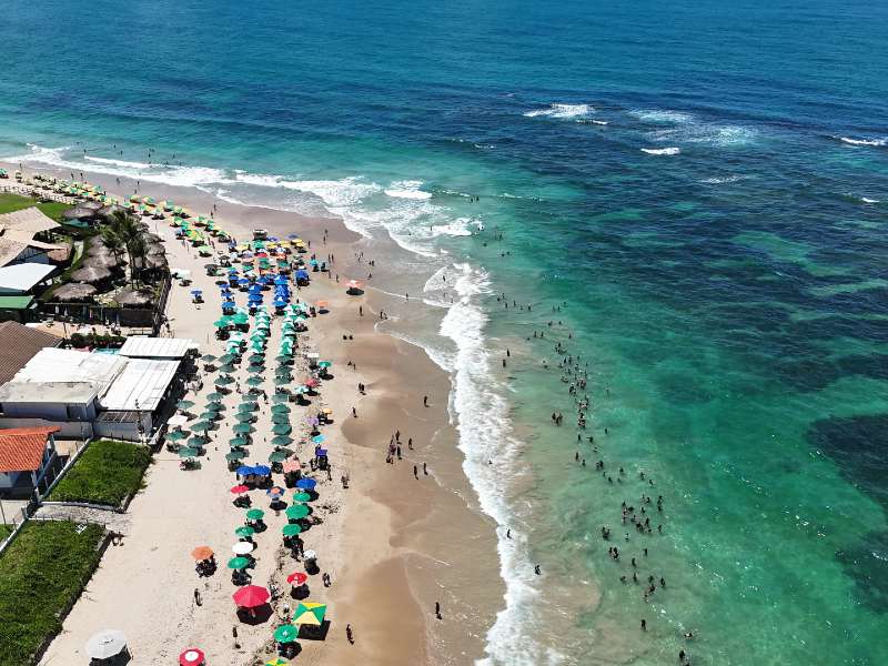 Praia do Centro de Porto de Galinhas com mar esverdeado e guarda-sóis na areia
